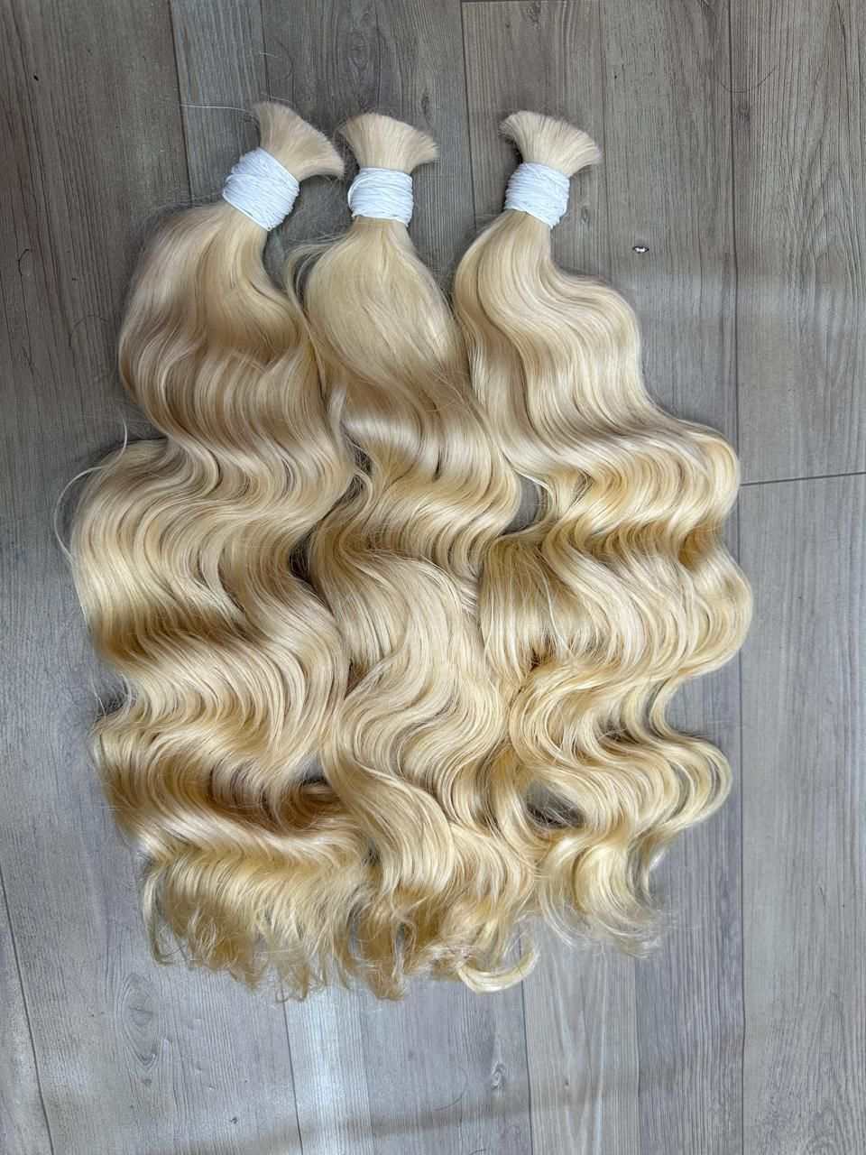 Cambodian 613 Blonde hair extensions in 16 to 30 inch lengths with smooth texture and vibrant blonde tone