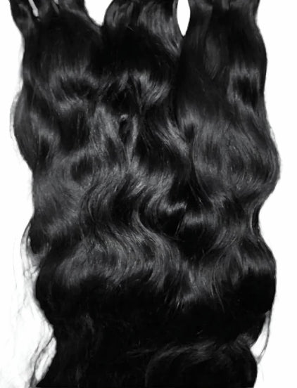 Close-up of luxurious Cambodian Wavy hair extensions in 16" to 30" lengths with natural texture and shine
