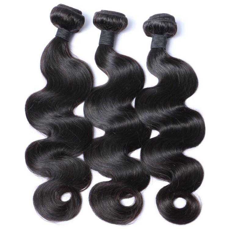 Three bundles of shiny black body wave human hair extensions neatly arranged